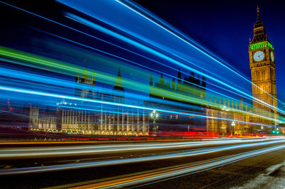 Low angle view of light trails in city at night