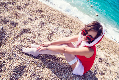 High angle portrait of young woman on beach