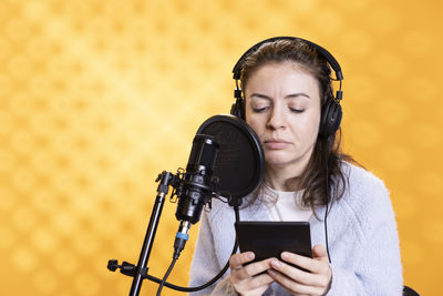 Portrait of young woman using mobile phone