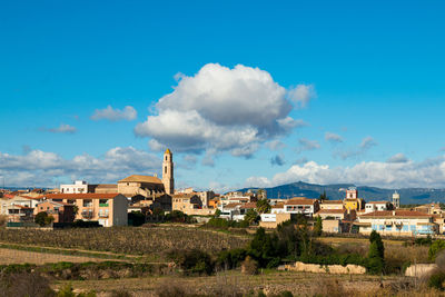 Buildings in city of brafim against blue sky