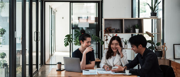 Portrait of smiling friends working at home