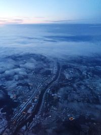 Aerial view of snow covered landscape against sky