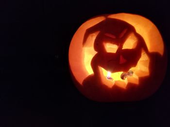 Close-up of illuminated pumpkin against black background