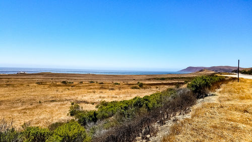 Scenic view of land against clear blue sky