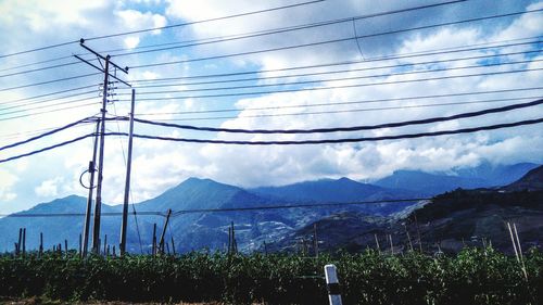 Scenic view of mountains against cloudy sky