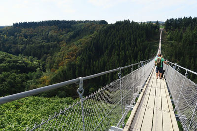 People standing on rope bridge at hunsruck