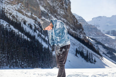 Side view of person standing on snow