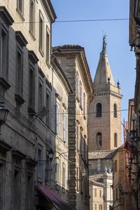 Low angle view of buildings in city against sky