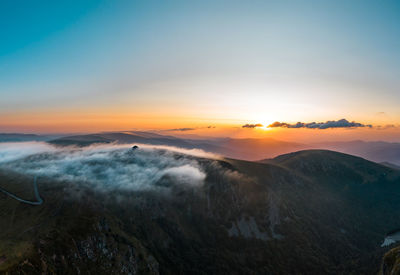 Scenic view of mountains against sky during sunset