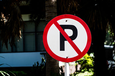 Close-up of road sign against trees