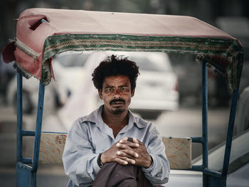Portrait of man sitting in cart