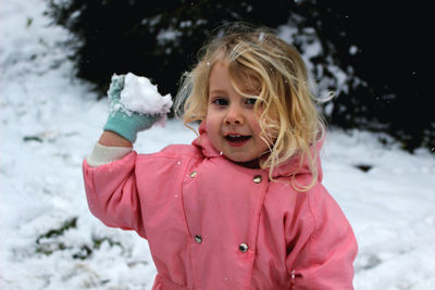 Portrait of a smiling girl in snow