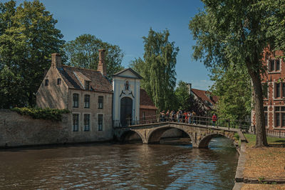 Buildings and bridge with people on canal of bruges. a town full of canals in belgium.