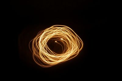 Close-up of light bulb over black background