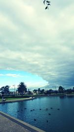 Scenic view of river against cloudy sky