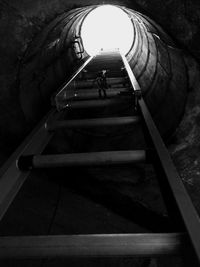 Man in illuminated tunnel