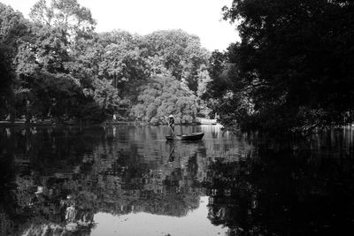 Scenic view of lake by trees against sky