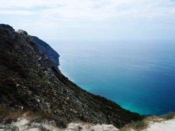 High angle view of sea and mountains against sky