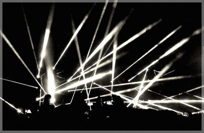Illuminated firework display at night