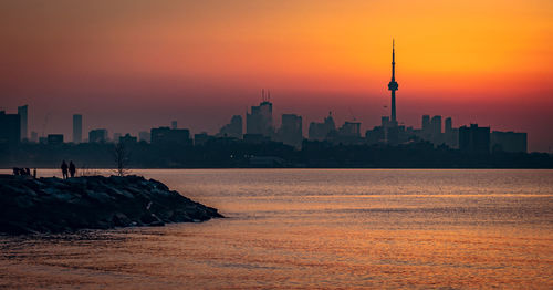 View of buildings in city during sunset