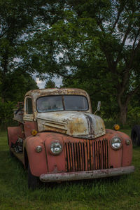 Abandoned vintage car on field