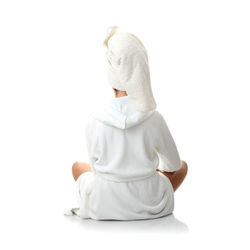 Rear view of girl sitting against white background