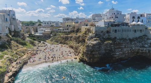 High angle view of people at beach against buildings in city