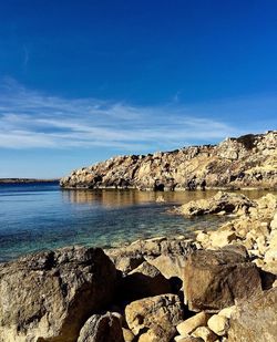 Scenic view of landscape against blue sky