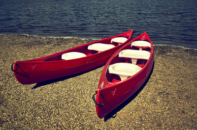 Red boat moored at sea shore