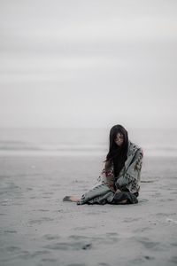 Woman sitting on beach