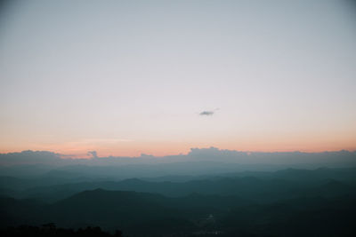 Scenic view of silhouette mountains against sky at sunset