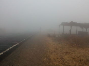 Scenic view of foggy weather against sky