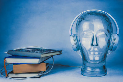 Close-up of eyeglasses on table against blue background