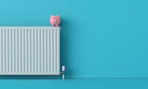 Close-up of piggy bank on wall