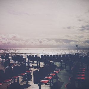 Empty chairs and tables in calm sea
