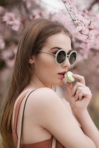 Fashion portrait of a beautiful girl eating green cookie