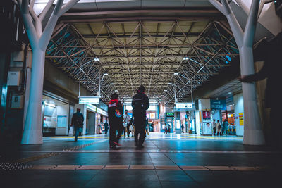 People walking in corridor of building