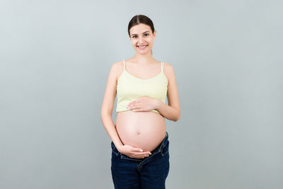 Portrait of a smiling young woman over white background