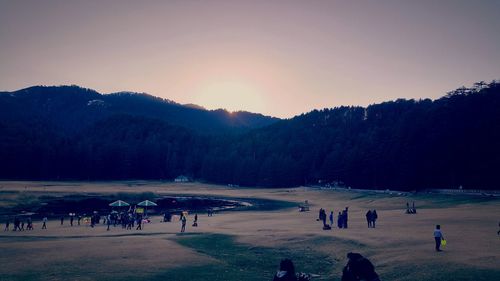 Group of people on field against sky