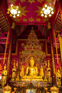 Low angle view of statue against illuminated building