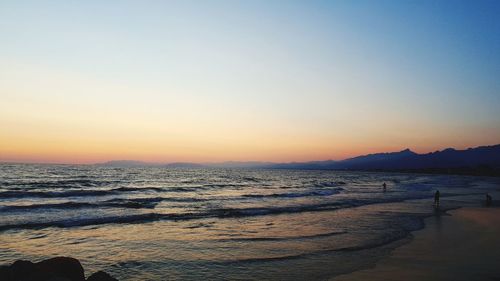 Scenic view of sea against clear sky during sunset