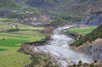 Scenic view of river amidst field