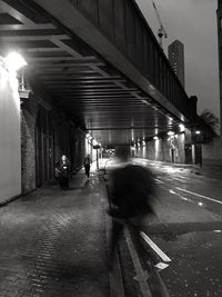 People in illuminated city at night