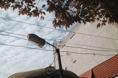 Low angle view of electricity pylon against sky