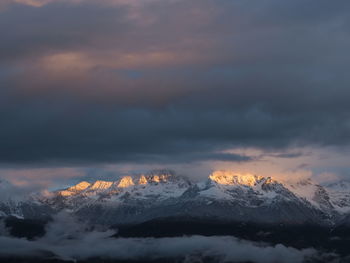 Scenic view of snowcapped mountains against sky during sunset