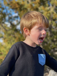 Close-up of boy looking away outdoors