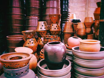 Various clay containers displayed for sale at market stall