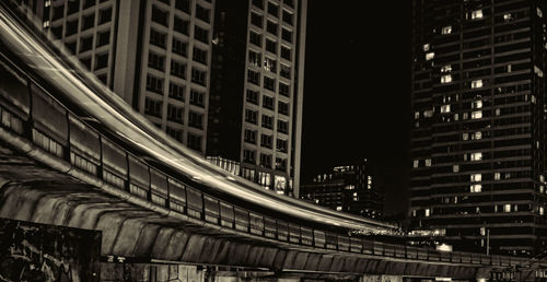 Low angle view of illuminated buildings in city at night