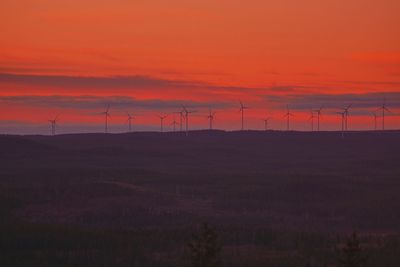 Scenic view of field against orange sky