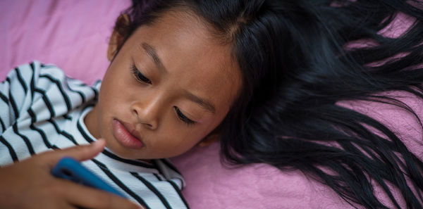 Girl using mobile phone at home